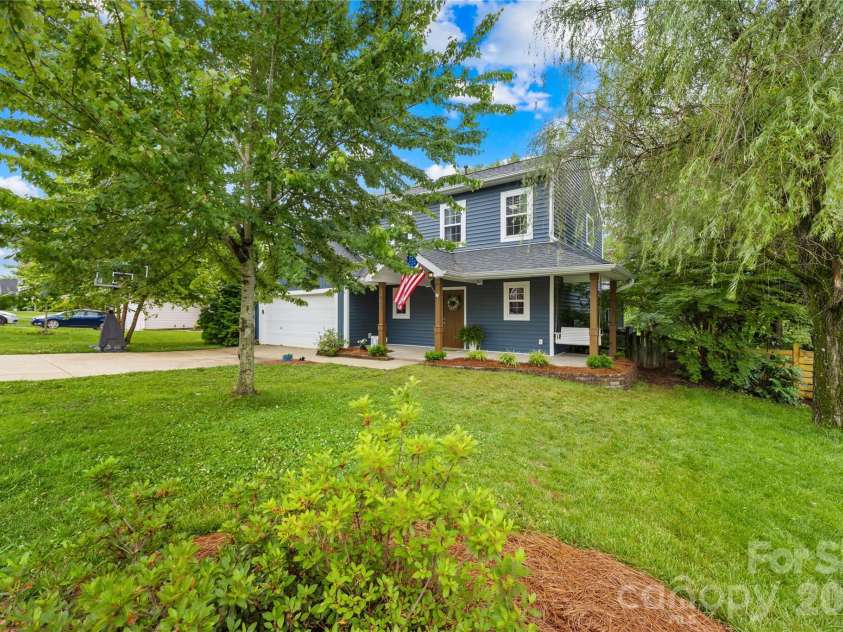 953 Rocky Meadows Lane, Concord, NC 28025.  MLS# CAR4384156, YatesRealty ID 30092. Front porch swing