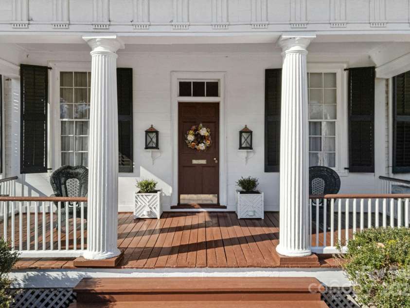104 Leslie Loop, Mooresville, NC 28115.  MLS# CAR4195674, YatesRealty ID 301. Front portico with 4 fluted Doric columns under a 2-story hip roof