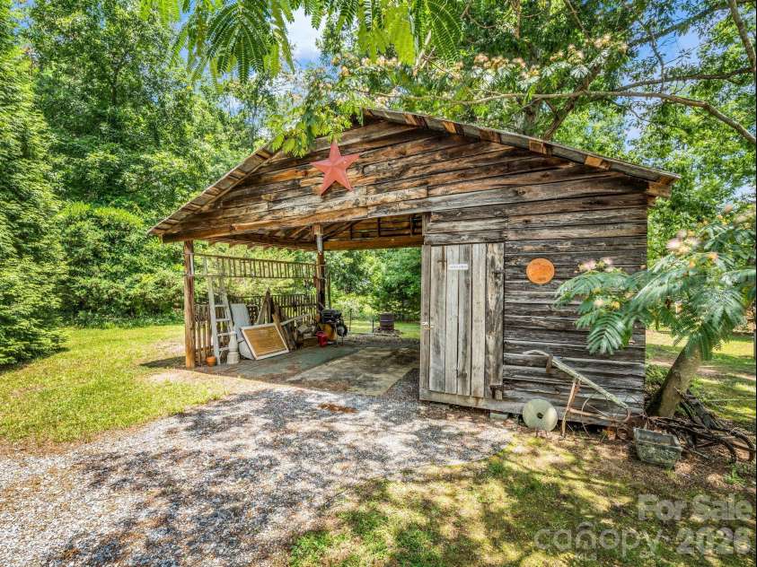 10 Deer Run Lane, Columbus, NC 28722.  MLS# CAR4392486, YatesRealty ID 30101. Barn with tool storage on the right.  Doubles as a carport.