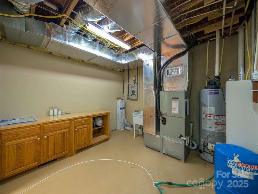 355 Rosewood Lane, Burnsville, NC 28714.  MLS# CAR4263679, YatesRealty ID 30113. Large Utility room in finished basement with laundry.