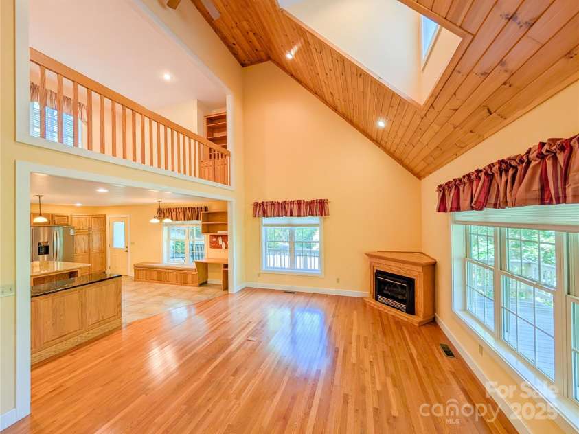 355 Rosewood Lane, Burnsville, NC 28714.  MLS# CAR4326302, YatesRealty ID 30113. Enjoy an open-concept design with two-story GR that features tongue & groove vaulted ceilings, recessed lighting, large picture windows with additional skylight for even more natural light, propane gas logs for cozy win