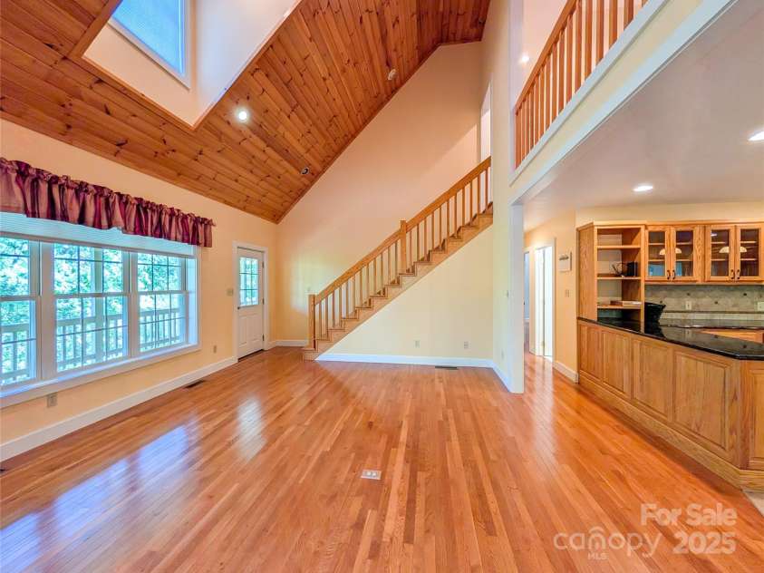 355 Rosewood Lane, Burnsville, NC 28714.  MLS# CAR4326302, YatesRealty ID 30113. Enjoy an open-concept design with two-story GR that features tongue & groove vaulted ceilings, recessed lighting, large picture windows with additional skylight for even more natural light, propane gas logs for cozy win