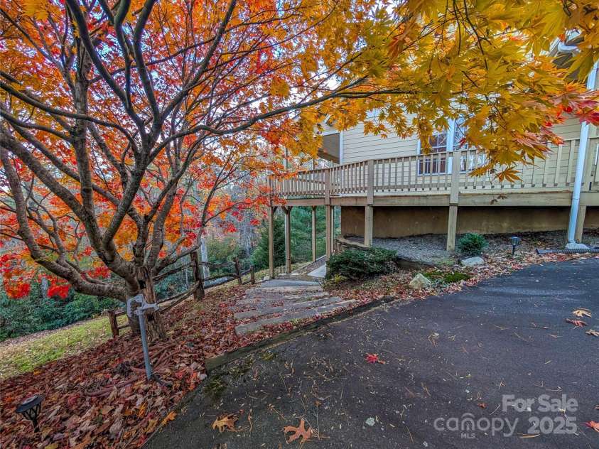 355 Rosewood Lane, Burnsville, NC 28714.  MLS# CAR4326302, YatesRealty ID 30113. Steps leading down to lower under the porch patio & access to fully finished basement