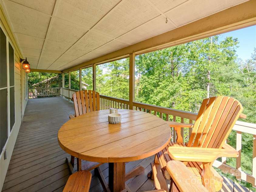 355 Rosewood Lane, Burnsville, NC 28714.  MLS# CAR4326302, YatesRealty ID 30113. The wrap around covered porch is such a relaxing place to enjoy nature & wind down after a long day with a glass of wine. Enjoy winter mountain views, bird watching, entertaining guests & more! A propane gas hookup for 