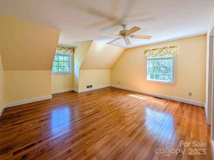 355 Rosewood Lane, Burnsville, NC 28714.  MLS# CAR4326302, YatesRealty ID 30113. Upstairs you'll find one of the primary ensuites included with this home that features beautiful hardwood flooring, natural lighting, walk-in closet with built-in shelving & full bathroom! 