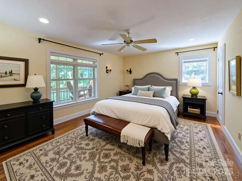 355 Rosewood Lane, Burnsville, NC 28714.  MLS# CAR4326302, YatesRealty ID 30113. Upstairs you'll find one of the primary ensuites included with this home that features beautiful hardwood flooring, natural lighting, walk-in closet with built-in shelving & full bathroom!