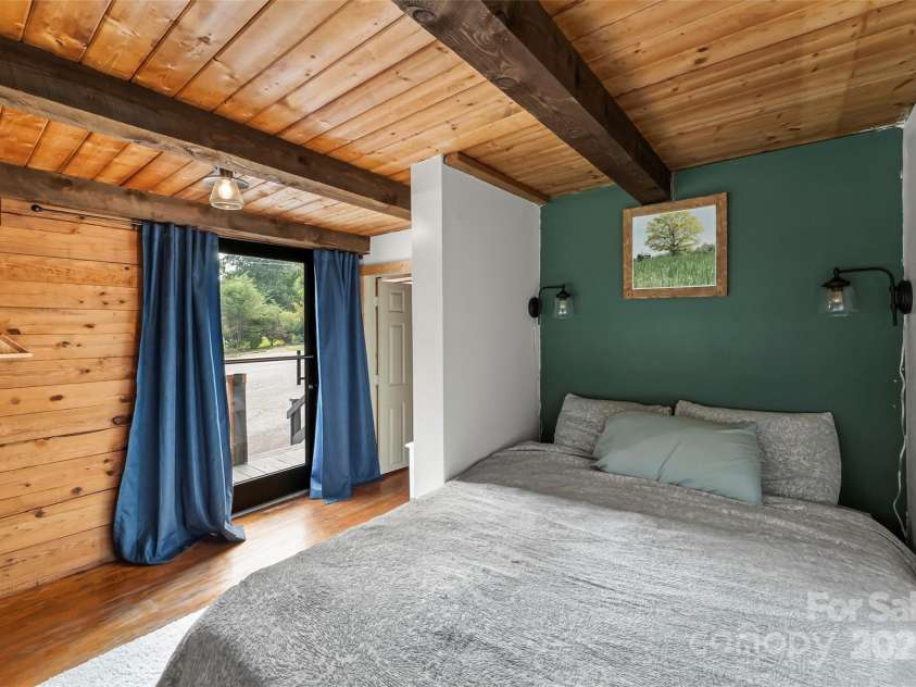 1623 Soco Road, Maggie Valley, NC 28751.  MLS# CAR4281971, YatesRealty ID 30118. Bedroom on main with access to wrap-around porch