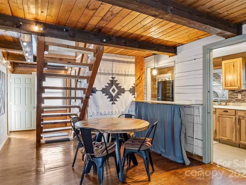 1623 Soco Road, Maggie Valley, NC 28751.  MLS# CAR4281971, YatesRealty ID 30118. Dining area with bar and pass-through window to kitchen