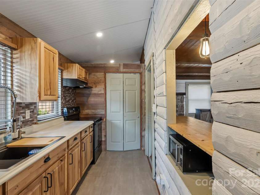 1623 Soco Road, Maggie Valley, NC 28751.  MLS# CAR4281971, YatesRealty ID 30118. Kitchen and laundry closet