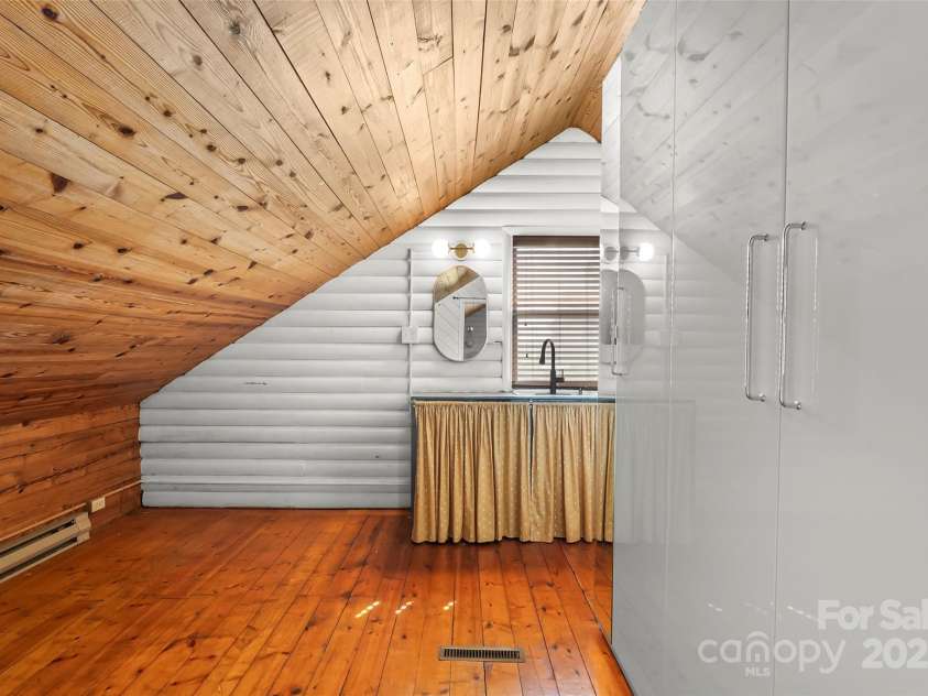 1623 Soco Road, Maggie Valley, NC 28751.  MLS# CAR4281971, YatesRealty ID 30118. Loft bedroom closet includes attached armoire and vanity w/ sink