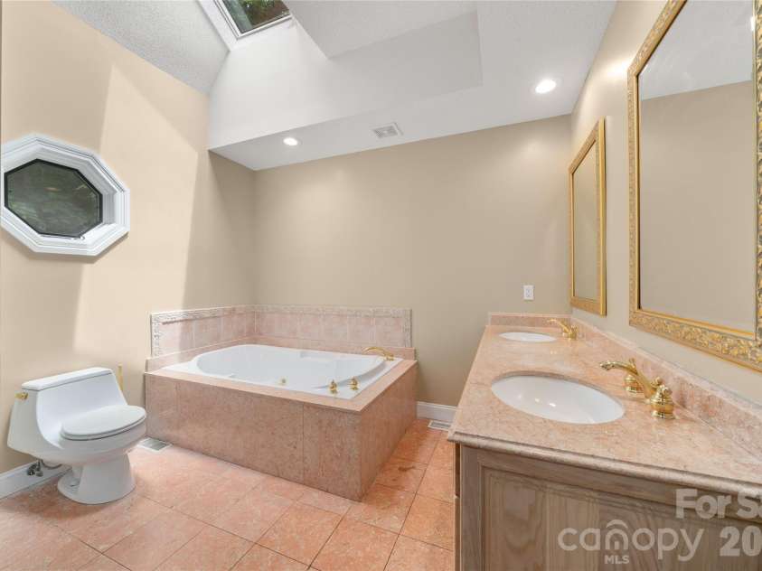 136 Rumbling Bald Road, Lake Lure, NC 28746.  MLS# CAR4393328, YatesRealty ID 30129. Primary bathroom, main level