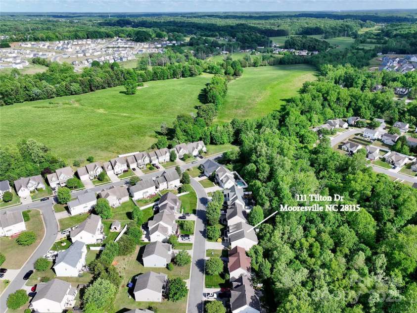 111 Tilton Drive, Mooresville, NC 28115.  MLS# CAR4254462, YatesRealty ID 30141. Aerial view of neighborhood and property backs up to woods.