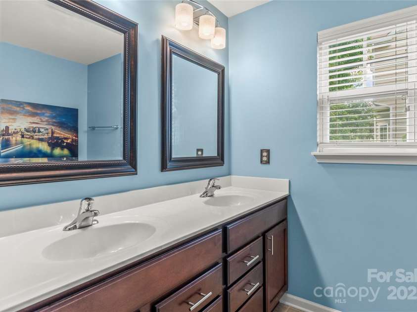 111 Tilton Drive, Mooresville, NC 28115.  MLS# CAR4254462, YatesRealty ID 30141. Main level primary ensuite with dual vanity ...