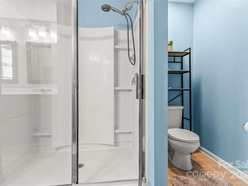 111 Tilton Drive, Mooresville, NC 28115.  MLS# CAR4254462, YatesRealty ID 30141. Main level primary large shower.