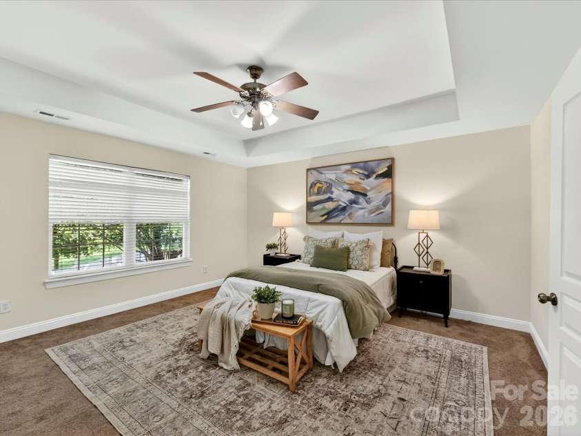 10507 Glenmeade Road, Cornelius, NC 28031.  MLS# CAR4391607, YatesRealty ID 30154. Expansive primary suite on upper level features a tray ceiling, abundant natural light, and ample room for a sitting area, creating a comfortable and private retreat.