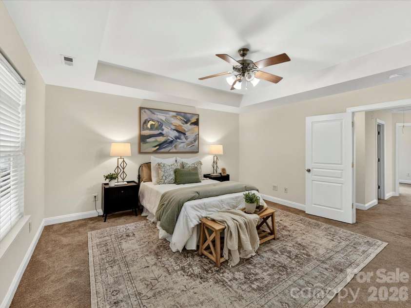 10507 Glenmeade Road, Cornelius, NC 28031.  MLS# CAR4391607, YatesRealty ID 30154. Expansive primary suite on upper level features a tray ceiling, abundant natural light, and ample room for a sitting area, creating a comfortable and private retreat.