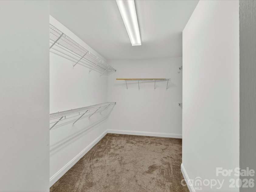 10507 Glenmeade Road, Cornelius, NC 28031.  MLS# CAR4391607, YatesRealty ID 30154. Generously sized walk-in closet offers ample storage and organization space with multiple shelving areas designed to accommodate an extensive wardrobe.
