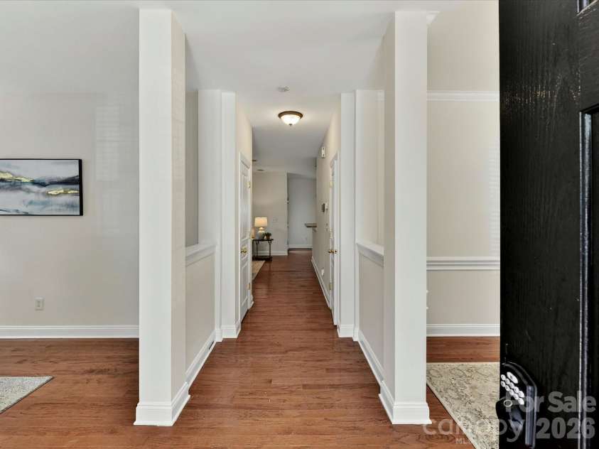 10507 Glenmeade Road, Cornelius, NC 28031.  MLS# CAR4391607, YatesRealty ID 30154. Inviting entryway features wood flooring, elegant column accents, and an open layout that creates a warm and welcoming first impression.