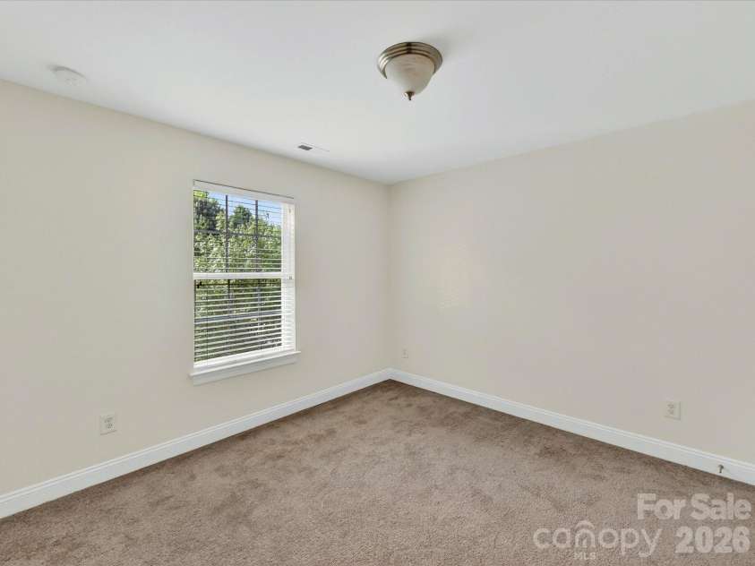 10507 Glenmeade Road, Cornelius, NC 28031.  MLS# CAR4391607, YatesRealty ID 30154. Spacious secondary bedroom offers comfortable accommodations with ample closet space, soft natural light, and a versatile layout to suit a variety of needs.