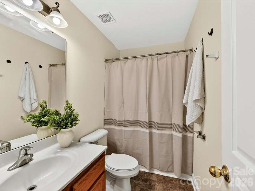 10507 Glenmeade Road, Cornelius, NC 28031.  MLS# CAR4391607, YatesRealty ID 30154. Well-appointed secondary full bathroom features a vanity with ample counter space and a tub/shower combination, providing convenience and functionality for family and guests.