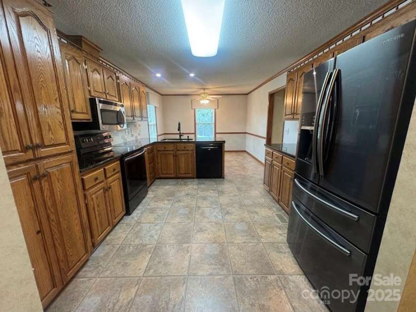 6339 River Front Drive, Harrisburg, NC 28075.  MLS# CAR4301925, YatesRealty ID 30155. Beautiful Wood cabinets and granite counter tops