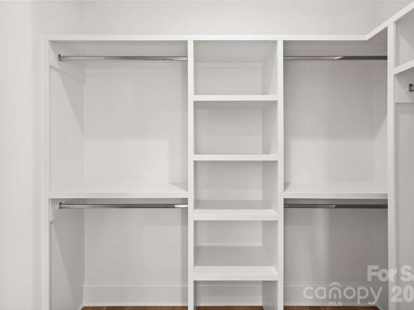 1316 Holmes Drive, Charlotte, NC 28209.  MLS# CAR4338664, YatesRealty ID 3016. 2nd Bedroom Closet, Upper Level, walk-in with shelving for sweaters, closet rods for shirt, skirts, jeans, dresses on the right-hand side and coats.