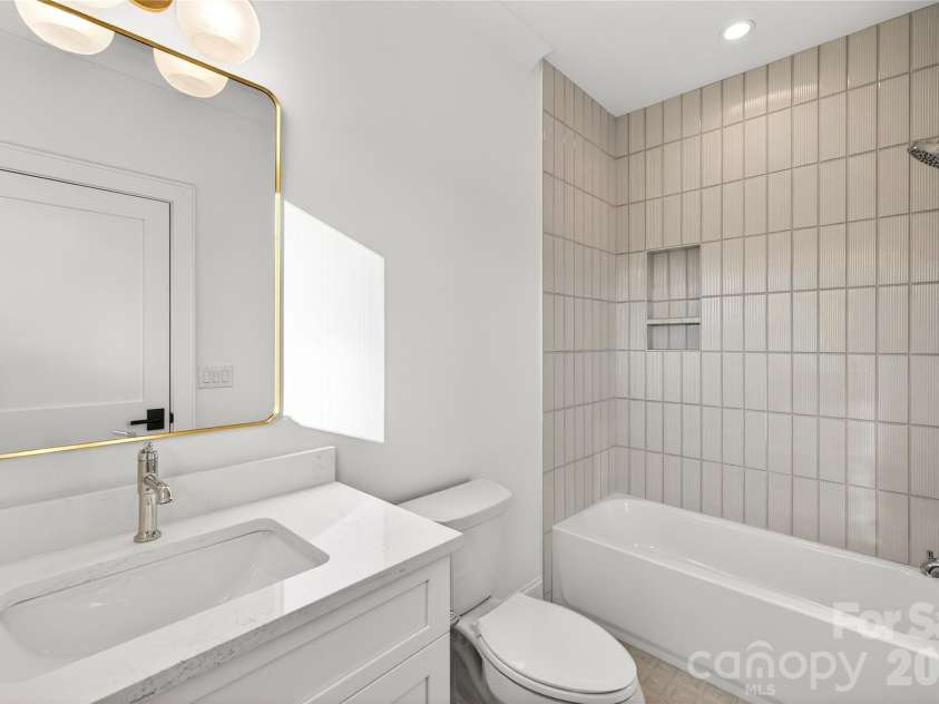 1316 Holmes Drive, Charlotte, NC 28209.  MLS# CAR4338664, YatesRealty ID 3016. Bathroom #2, Upper.  Full bathtub, rainforest shower head, beautiful rectangular mirror, 2-light light fixture.