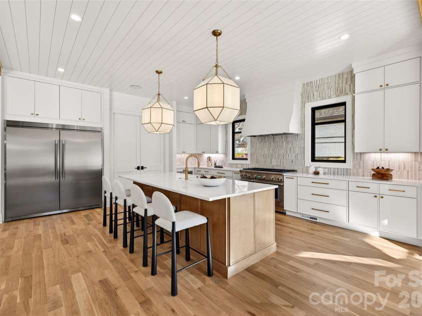 1316 Holmes Drive, Charlotte, NC 28209.  MLS# CAR4338664, YatesRealty ID 3016. Beautiful view of the Kitchen. Nice large island with sink. Gorgeous double door stainless refrigerator. To the right of the refrigerator is the walk-in wet bar, walk-in pantry. Microwave. Thermador gas range, oven, 6 bur