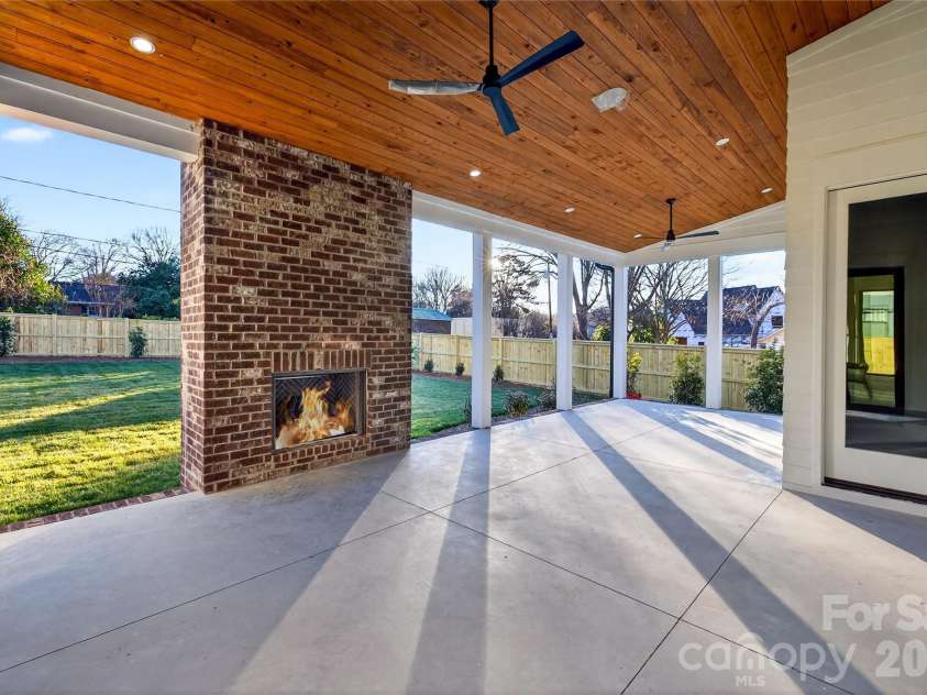 1316 Holmes Drive, Charlotte, NC 28209.  MLS# CAR4338664, YatesRealty ID 3016. Beautiful view of the large Rear Porch looking out on the back lawn. Plenty of space for dining and sitting areas. Door leads to the Bedroom on Main.