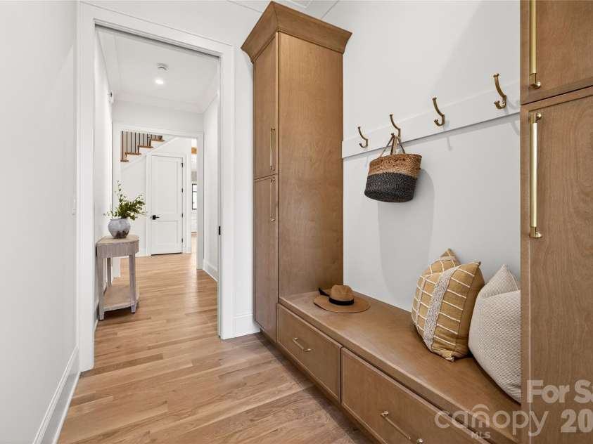 1316 Holmes Drive, Charlotte, NC 28209.  MLS# CAR4338664, YatesRealty ID 3016. Drop Zone from the 2-car Garage. Beautiful built-in cabinet for coats, boots, athletic equipment and more! Connects to the side hallway off the Entry Hall.