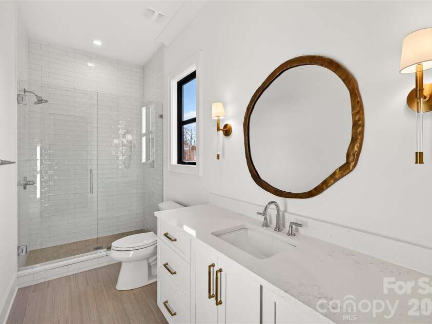 1316 Holmes Drive, Charlotte, NC 28209.  MLS# CAR4338664, YatesRealty ID 3016. Full Bath connecting to the Bedroom on Main. Shower. White subway tile.