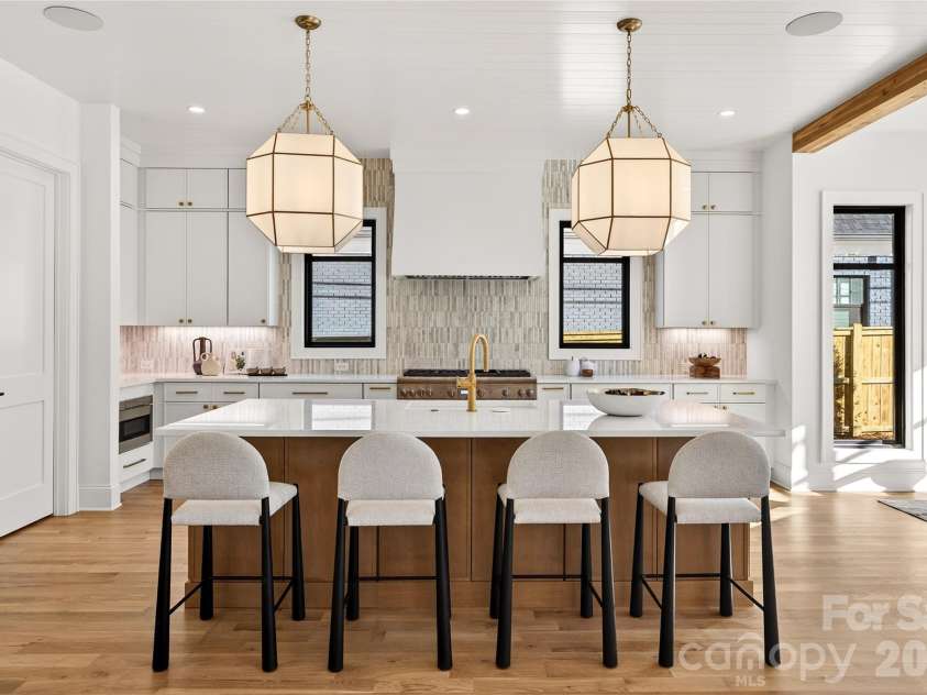 1316 Holmes Drive, Charlotte, NC 28209.  MLS# CAR4338664, YatesRealty ID 3016. Looking toward the Kitchen from the Living Room. Beautiful backsplash. Doors on left lead to walk-in wet bar and walk-in pantry. Microwave is in left corner of the photo. 