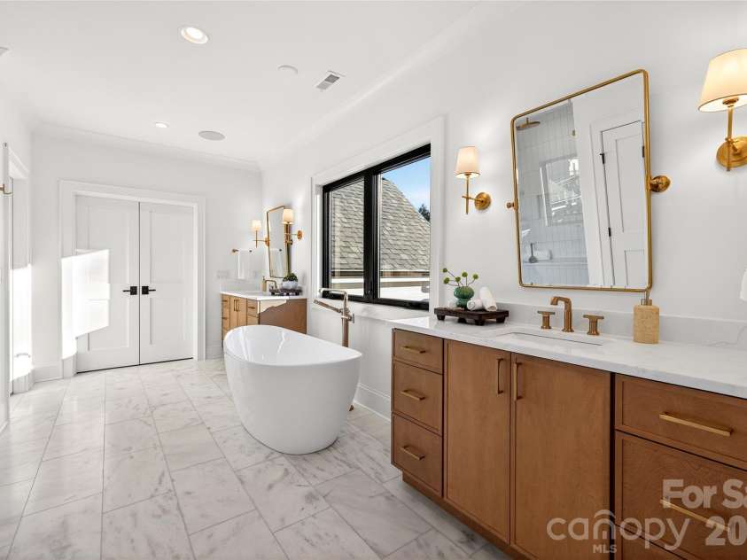 1316 Holmes Drive, Charlotte, NC 28209.  MLS# CAR4338664, YatesRealty ID 3016. Master Bathroom (Upper Level). Gorgeous freestanding tub in center of room. Large shower with rainforest shower head across from tub. 2 vanity sinks.
