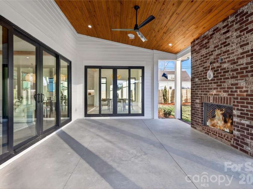 1316 Holmes Drive, Charlotte, NC 28209.  MLS# CAR4338664, YatesRealty ID 3016. Rear Porch. Concrete floor. Brick fireplace with gas logs. Rich wood ceiling, recessed lighting, ceiling fans. 