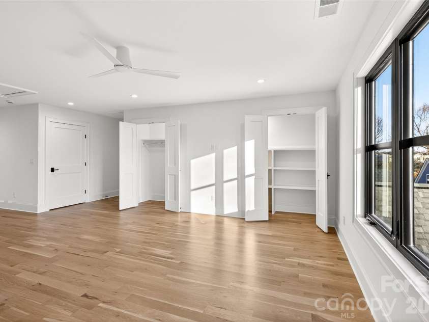 1316 Holmes Drive, Charlotte, NC 28209.  MLS# CAR4338664, YatesRealty ID 3016. Room on the 3rd Level of the home. Double closets, one on left has closet hanger rods and the closet on the right has permanent shelving. 