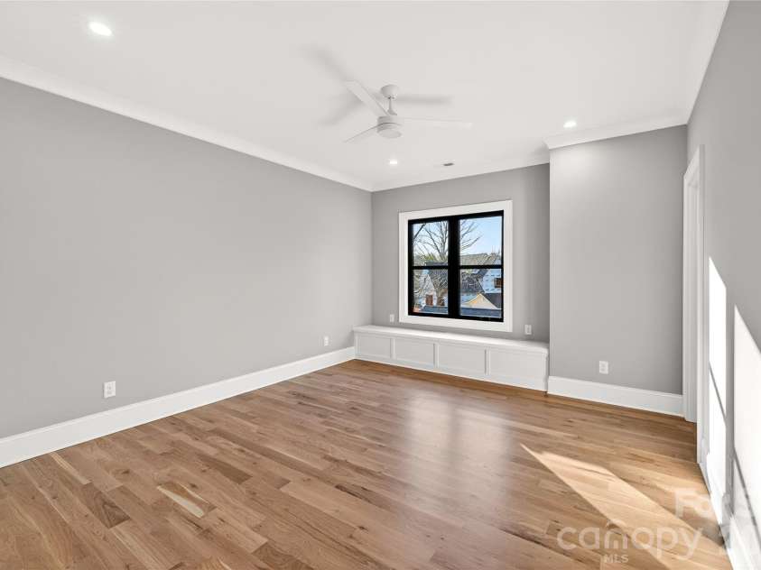 1316 Holmes Drive, Charlotte, NC 28209.  MLS# CAR4338664, YatesRealty ID 3016. Upper Level, Bedroom #2. Gray walls, ceiling fan, blanket chest built-in. In-suite Bath. Pocket door walk-in closet. 