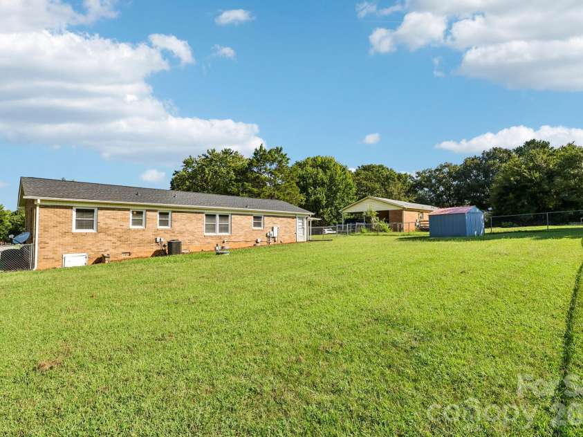 5111 Hawthorne Lane, Shelby, NC 28152.  MLS# CAR4422090, YatesRealty ID 30178. Flat Backyard with storage shed