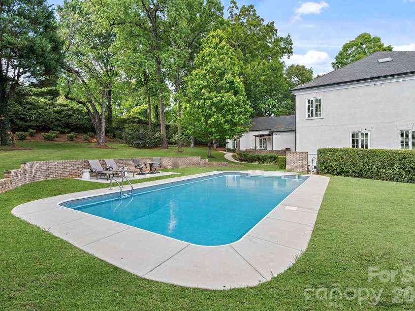 8124 Greencastle Drive, Charlotte, NC 28210.  MLS# CAR4364842, YatesRealty ID 30191. Backyard pool and lounge area.