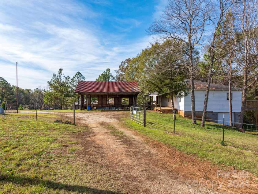 152 Long Branch Road, Chesnee, SC 29323.  MLS# CAR4204540, YatesRealty ID 302. Entrance to the property from Long Branch Road.  Ample room for parking and easy access to a one level house plus basement.  Additional buildings are behind the carport.  