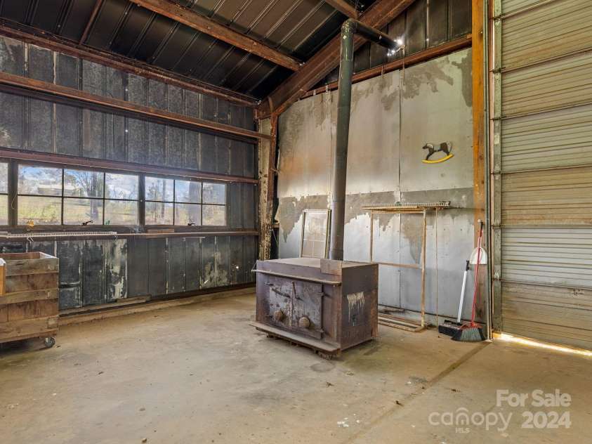 152 Long Branch Road, Chesnee, SC 29323.  MLS# CAR4204540, YatesRealty ID 302. Wood stove inside of the large building.