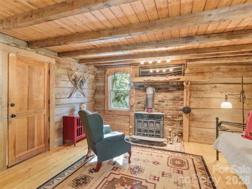 996 HALLS CHAPEL Road, Burnsville, NC 28714.  MLS# CAR4314014, YatesRealty ID 302. Living room w/wood stove