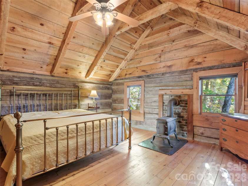 996 HALLS CHAPEL Road, Burnsville, NC 28714.  MLS# CAR4314014, YatesRealty ID 302. Wood stove in bedroom
