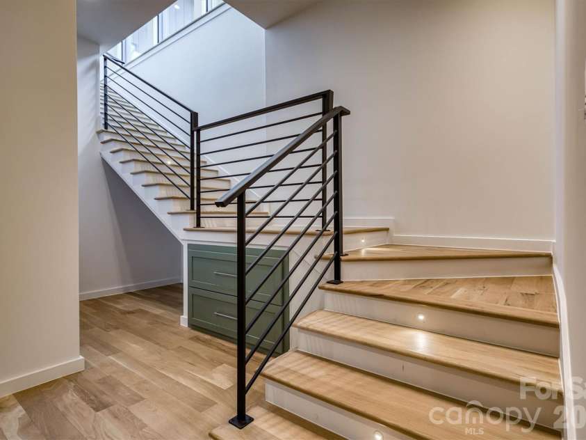 463 Summit Trail, Nebo, NC 28761.  MLS# CAR4350199, YatesRealty ID 3021. Custom metal railings and additional storage in stairwell