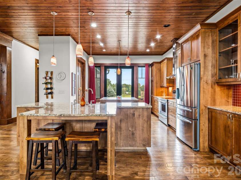 4862 Pinnacle Mountain Road, Zirconia, NC 28790.  MLS# CAR4383649, YatesRealty ID 30211. Expansive granite kitchen with tile backsplash