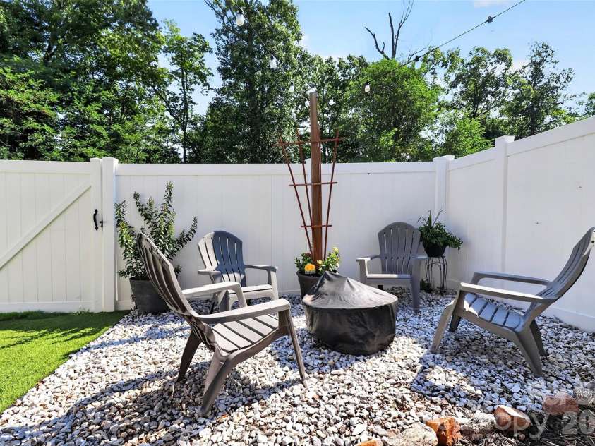 773 River Park Road, Belmont, NC 28012.  MLS# CAR4391220, YatesRealty ID 30213. An Invitation to Unwind. Designed with a fire pit in mind, this intimate seating area creates the perfect setting for entertaining, quiet conversations, and relaxing nights outdoors.