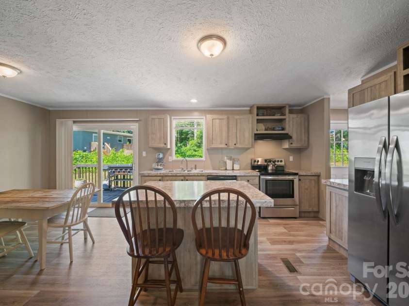 151 Field Sparrow Lane, Hendersonville, NC 28792.  MLS# CAR4388296, YatesRealty ID 30216. Kitchen + Dining Room