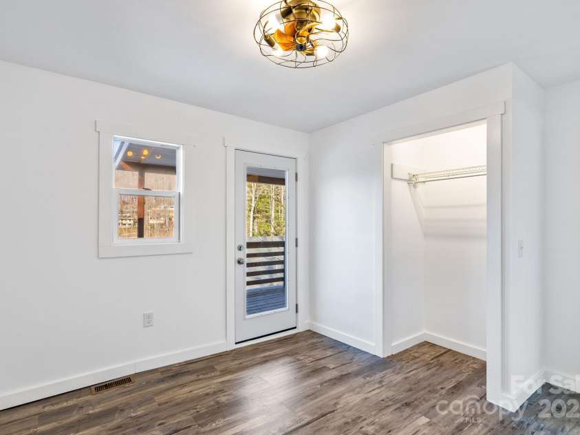 86 Chestnut Hill Road, Gerton, NC 28735.  MLS# CAR4213931, YatesRealty ID 3024. A flexible 11x10 room with a closet is the perfect setup for a home office, guest retreat, or creative studio! Ample closet space and modern lighting with fan make it both functional and inviting.