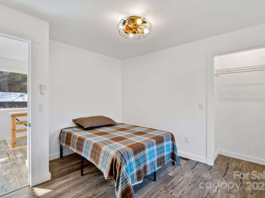 86 Chestnut Hill Road, Gerton, NC 28735.  MLS# CAR4213931, YatesRealty ID 3024. The bedroom (#2) has a large closet, and natural light streaming through the windows. The inviting atmosphere makes it a restful retreat.