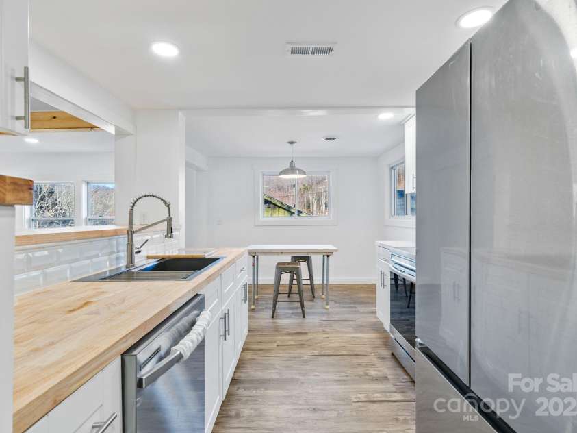 86 Chestnut Hill Road, Gerton, NC 28735.  MLS# CAR4213931, YatesRealty ID 3024. The layout emphasizes functionality and openness, with multiple windows allowing natural light to flood the space.