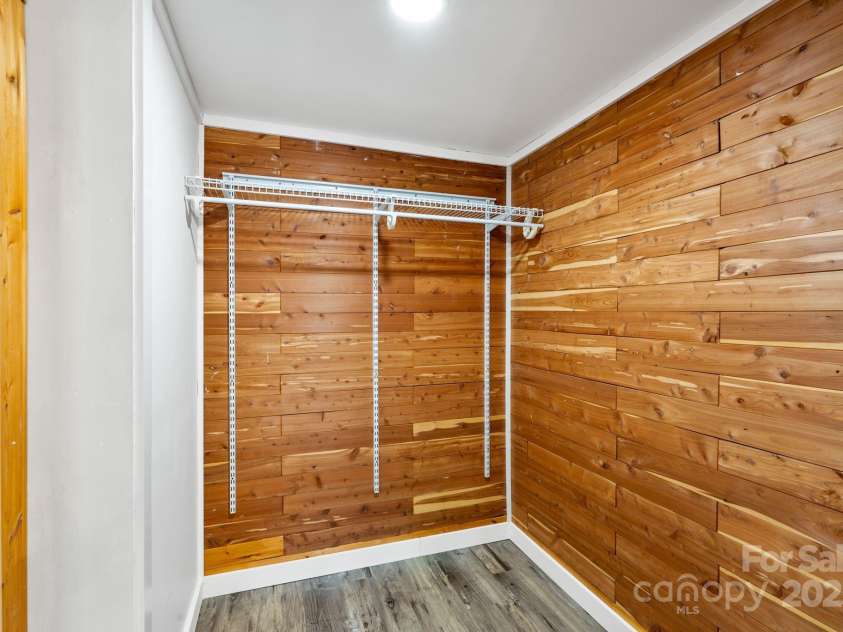 86 Chestnut Hill Road, Gerton, NC 28735.  MLS# CAR4213931, YatesRealty ID 3024. This cedar-lined walk-in closet adds a luxurious touch to the home. The natural wood provides a fresh, aromatic scent while offering ample storage space for clothes and accessories.